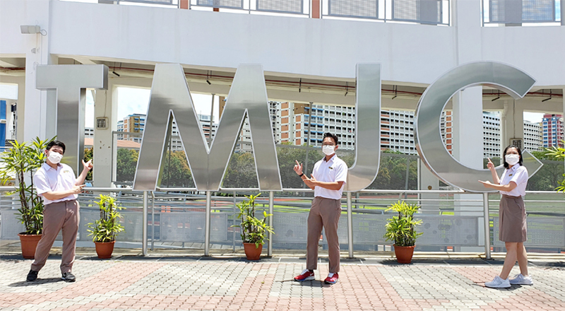 Tampines Meridian JC students wearing white shirts with khaki trousers and a skirt